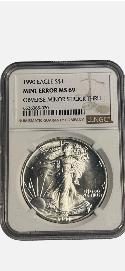 1990 $1 AMERICAN SILVER EAGLE MS69 MINT ERROR OBVERSE STRUCK THRU NGC